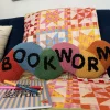 ban.do x Peking Handicraft Bookworm Hook Pillow^ Home + Décor
